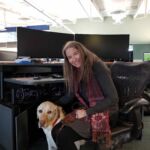 Lynn Gifford, a specialist in trauma stewardship, joins E-Comm as its full-time Workplace Wellness manager along with certified assistance dog Koltan, a four-year-old Yellow Labrador Retriever.
